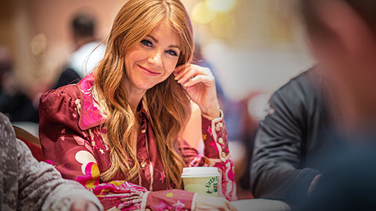 Photo of Lynn Gilmartin seated at a poker table